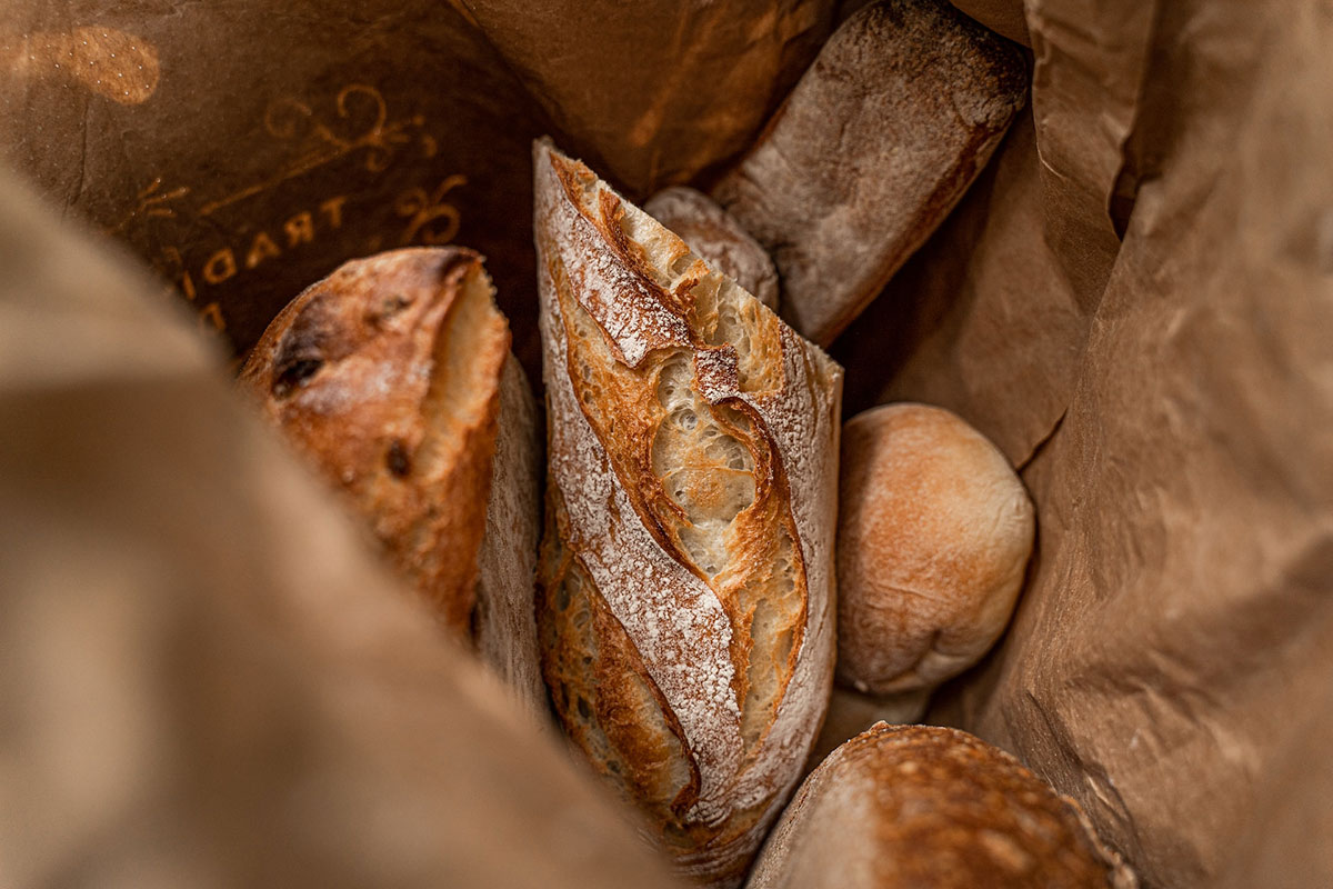 A basket of French baguettes which are naturally vegan