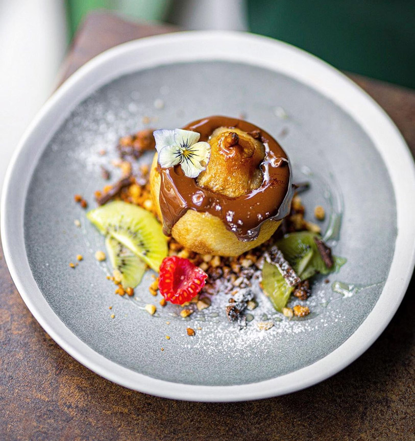 Roasted pear with melted chocolate, buckwheat granola, and almonds at Le Potager de Charlotte in Paris