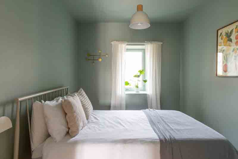 Twin bedroom in a french gite with relaxing blue coloured walls 
